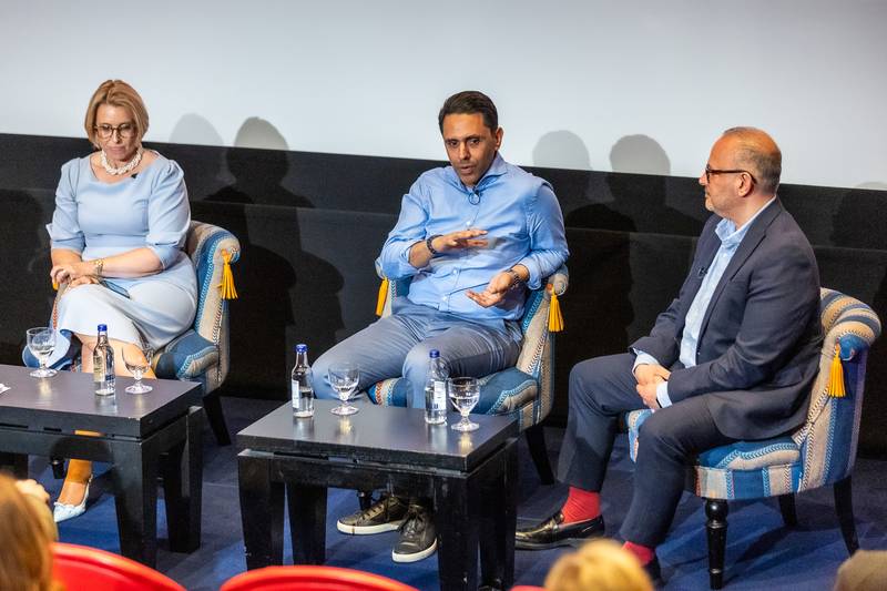 SuperSkills Rahim Hirji panel discussion three speakers gesturing