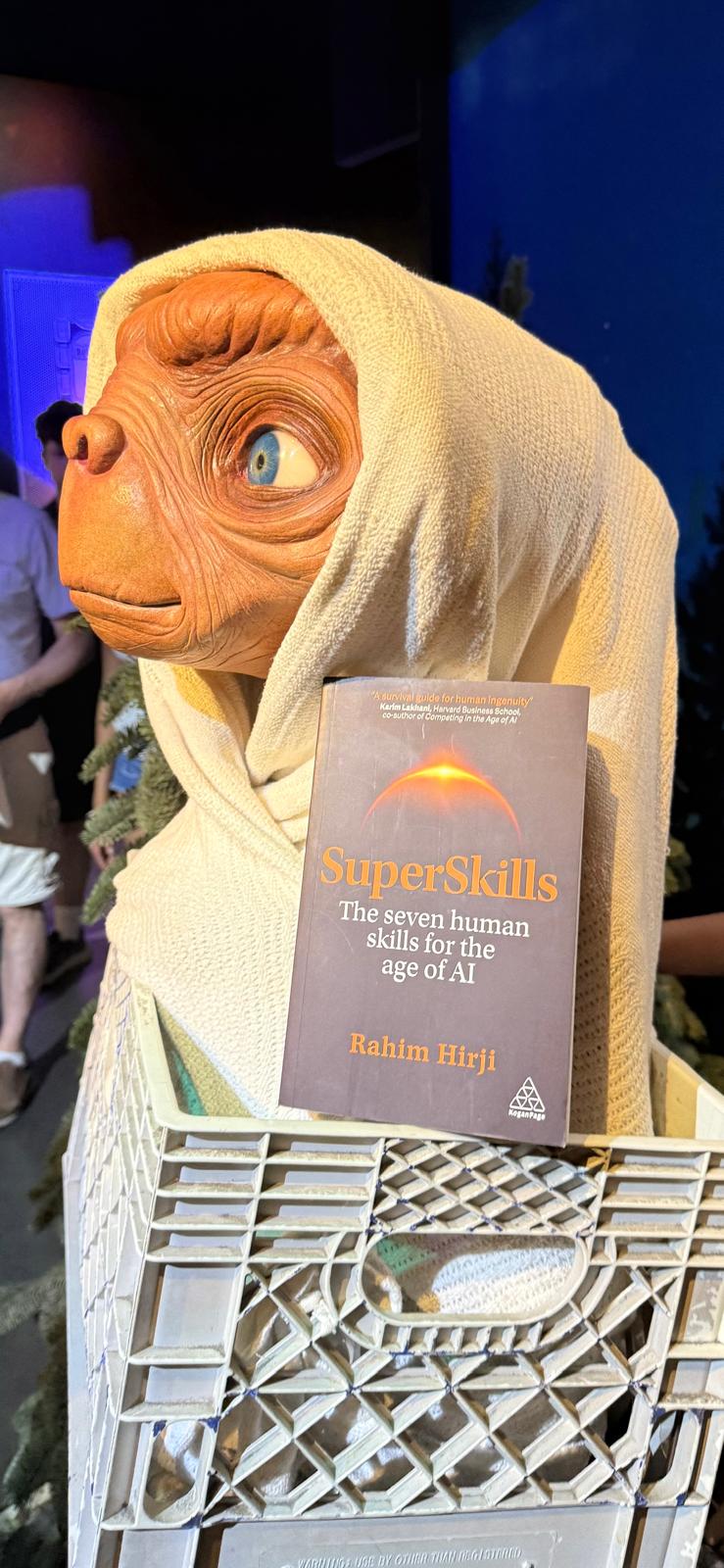 An ET figure holding a copy of SuperSkills